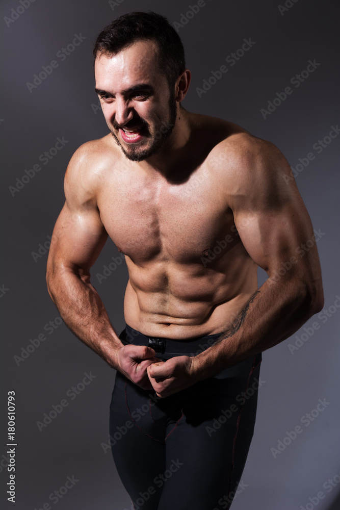 Muscular screaming man with a naked torso. Muscular screaming man with a naked torso.