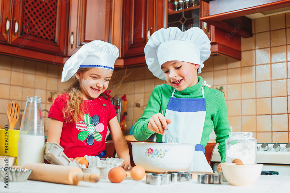 happy family funny kids are preparing the dough, bake cookies in the kitchen
