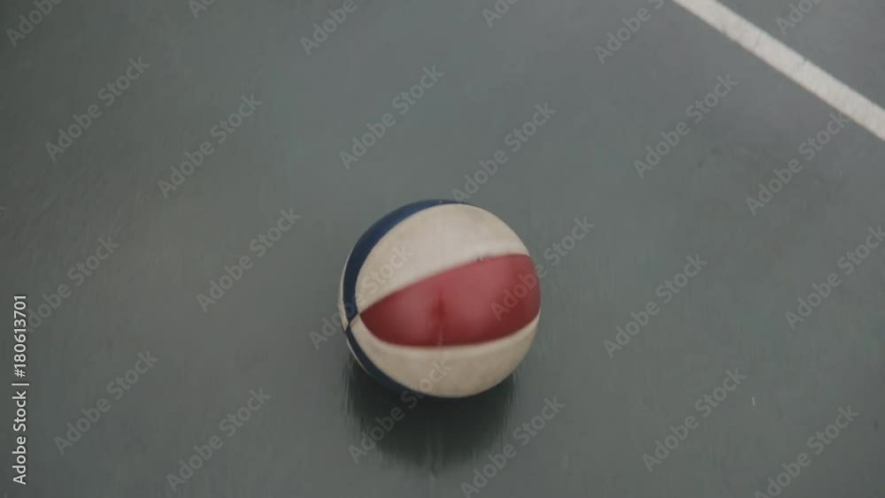 Ball rolling on the ground in basketball court Ball rolling on the ground in basketball court