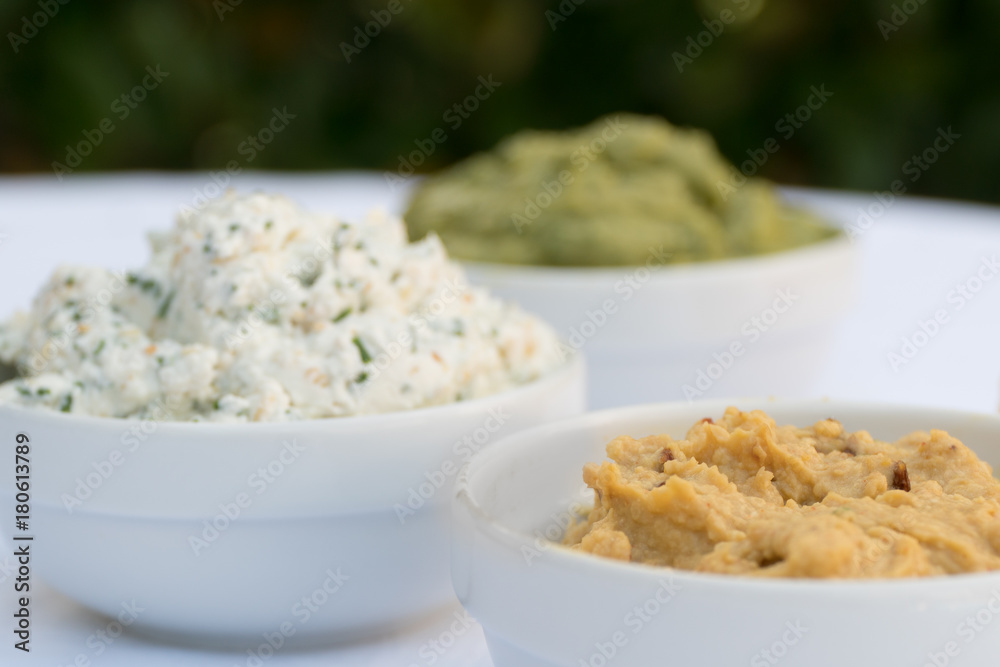Hummus, cheese and guacamole dip bowls Hummus, cheese and guacamole dip bowls