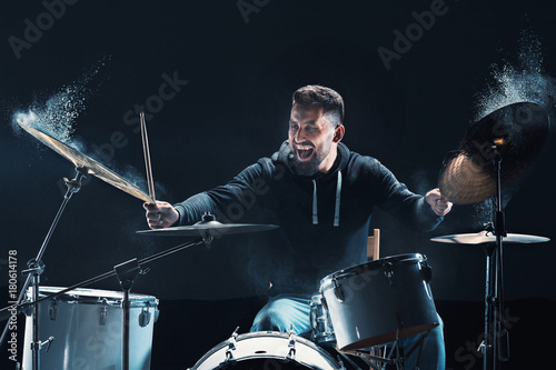 Fototapeta Drummer rehearsing on drums before rock concert