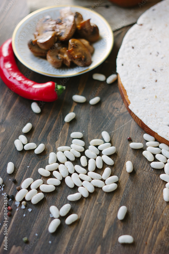 Dry white kidney beans on wooden table Dry white kidney beans on wooden table