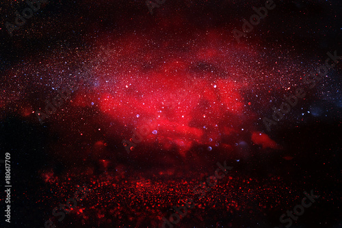 black and red glitter lights background. defocused