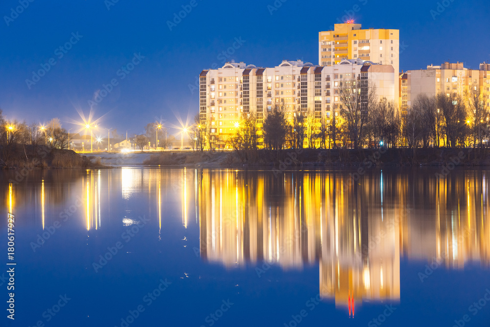 Night View Of Urban Residential Area Overlooks To City Lake Or River Park