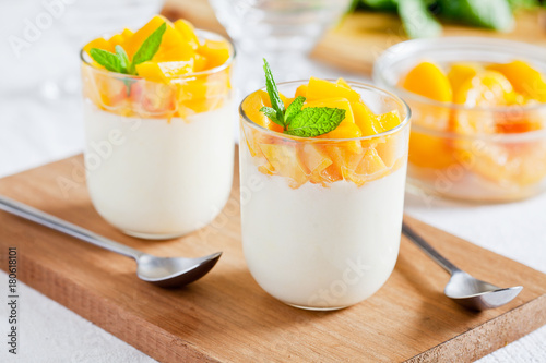 Fototapeta Naklejka Na Ścianę i Meble -  Glasses Of Yogurt With Poached Peach