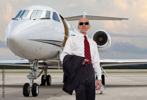 Business man next to a private jet