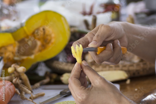 Close up hands when slice finger root Ingredients for Thai Cuisine