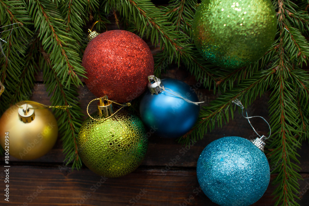 New Year's green balls with fir branches on a wooden background. Top view New Year's green balls with fir branches on a wooden background. Top view