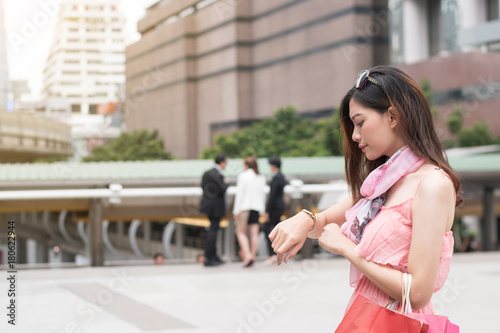 holiday lifestyle concept : girl waiting , young casual woman see watch