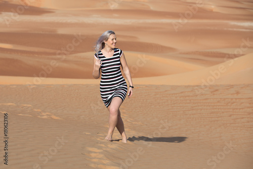 Young woman walking around desert. photo