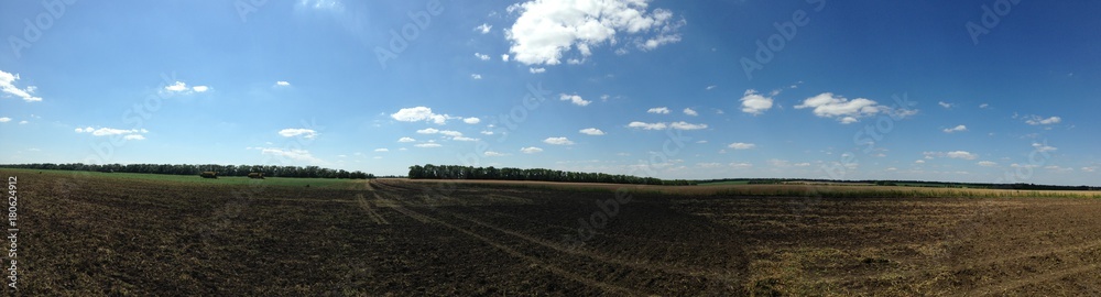 View of beautiful agricultural fields and meadows in the countryside. It is a clear, bright Autumn day with blue sky.