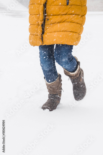 Legs of running girl in winter photo