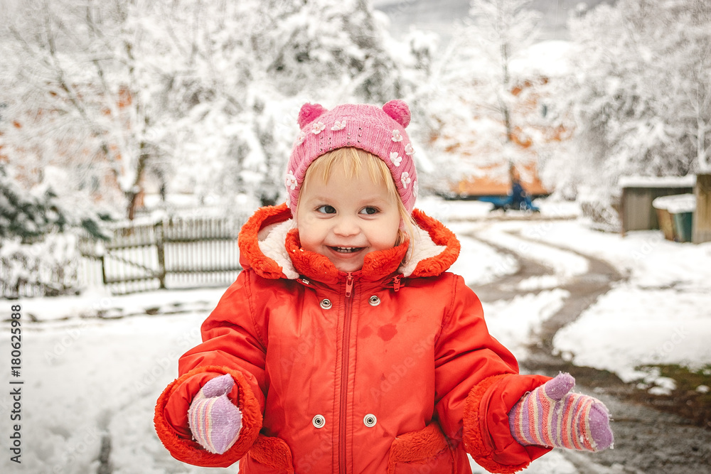 little girl in red overalls playing in the snow little girl in red overalls playing in the snow