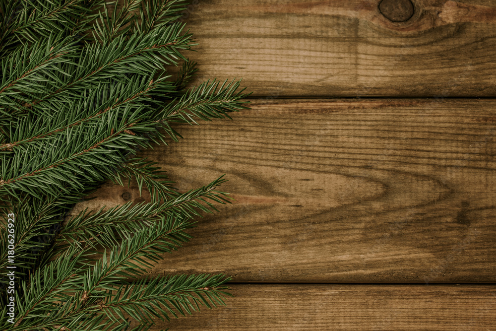 Empty copy space christmas background. Green needles branch on wooden desks. Empty copy space christmas background. Green needles branch on wooden desks.
