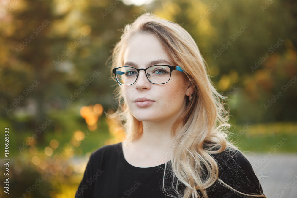 Beautiful woman in glasses on a autumn yellow background closeup portrait Beautiful woman in glasses on a autumn yellow background closeup portrait