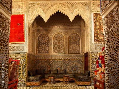 Typical Moroccan riad house with brown mosaic and carpets - Fes, Africa, Morocco photo