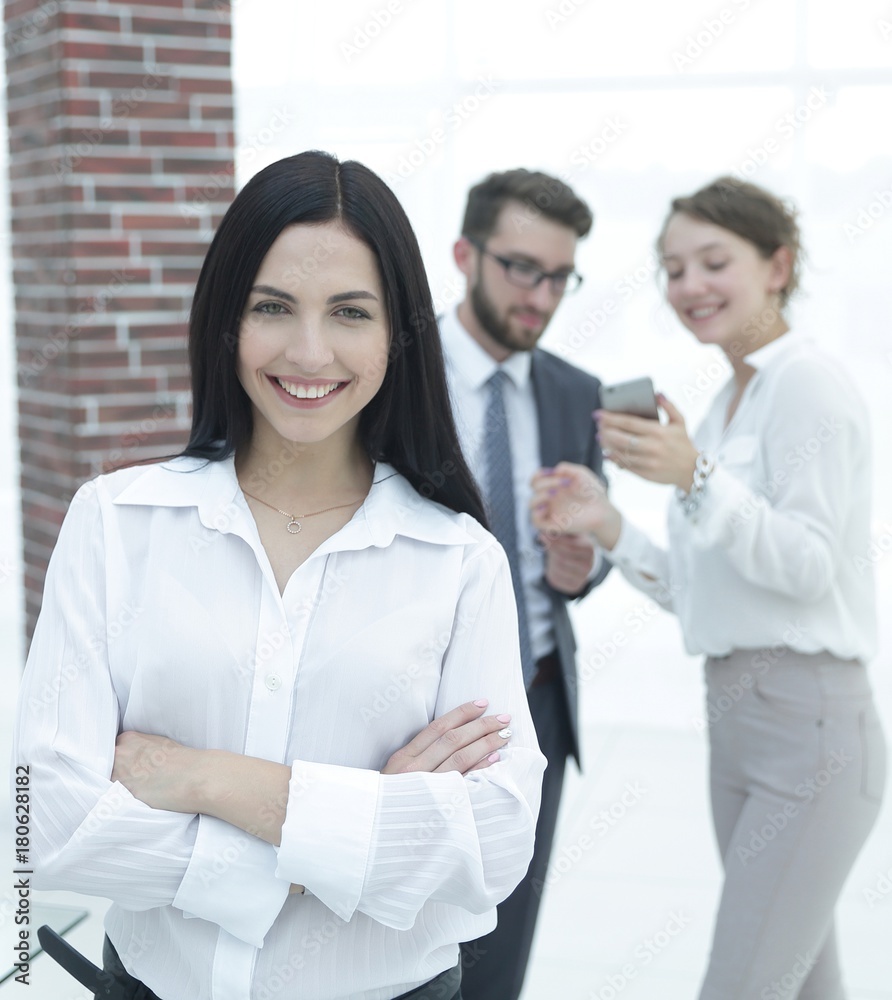 successful young business woman against the background of colleagues. successful young business woman against the background of colleagues.