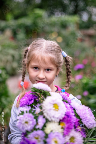 Little girl with a bouquet of flowers.
