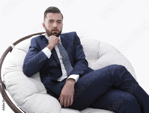 successful businessman sitting in a chair.