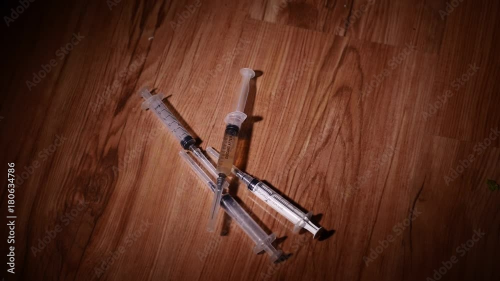 Falling syringes. Syringe drug abuse concept. Slow motion