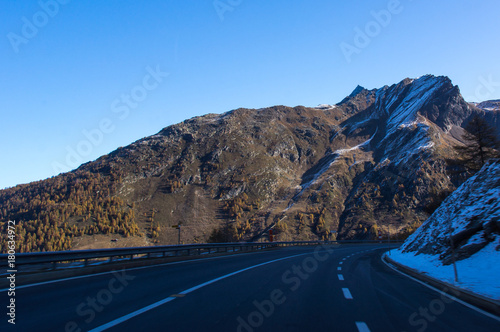 Beautiful road in the Swiss Alps. Mountain peaks covered with snow. Simplon pass