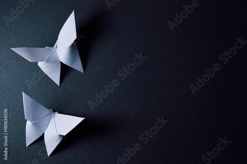 origami butterflies on dark background