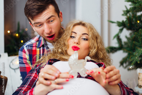 young parents are waiting for a baby and with a fascination look