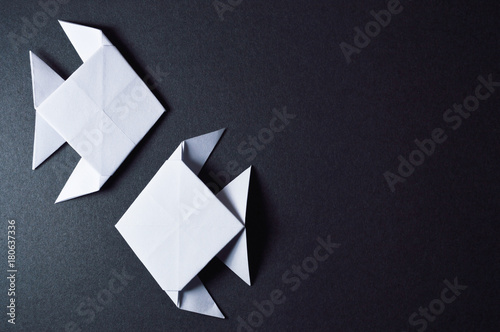 origami fishes on dark background