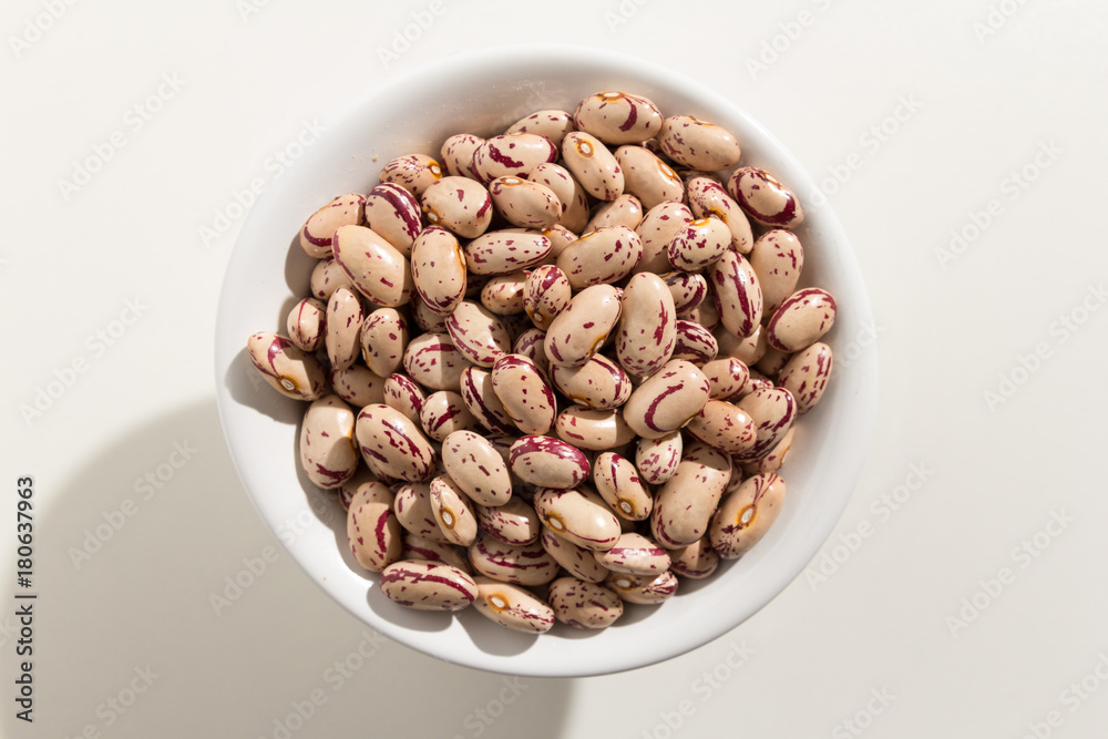 Sugar Bean legume. Top view of grains in a bowl. White background Sugar Bean legume. Top view of grains in a bowl. White background