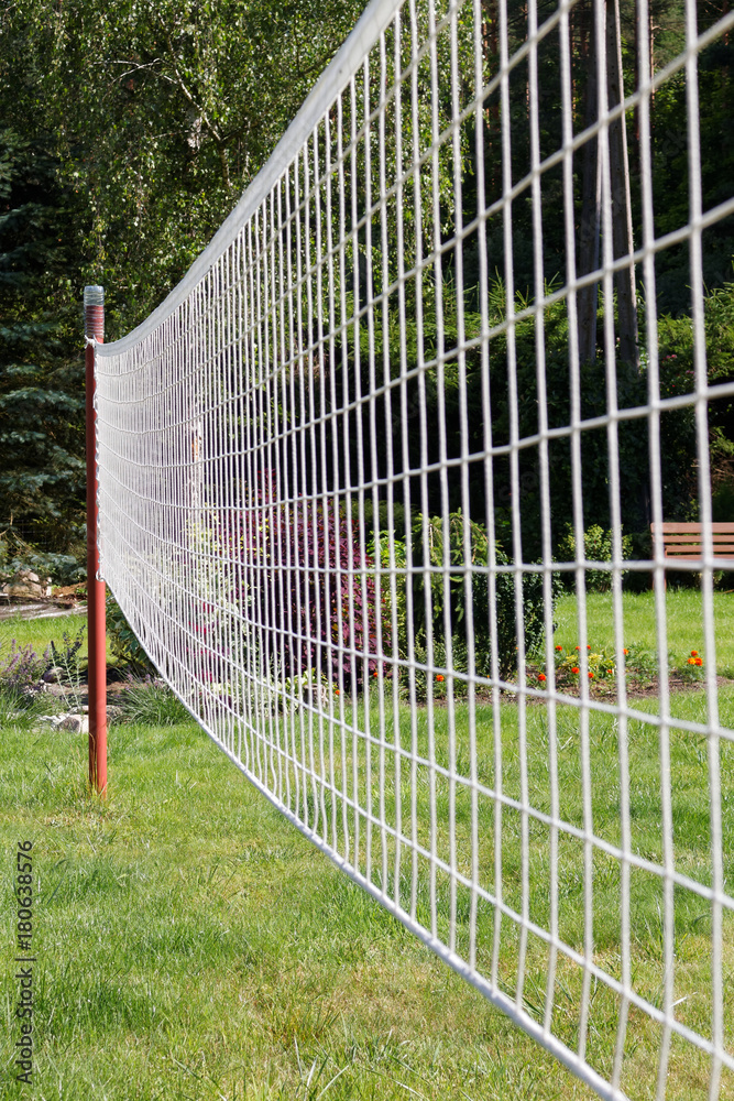Volleyball net on a background of green grass.
