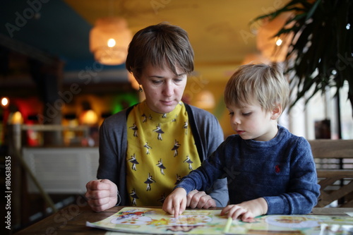 Woman with child choosing dishes