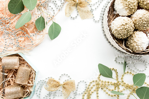  happy holidays and frame made of christmas decoration with christmas balls, tinsel, bow, eucalyptus. christmas wallpaper. flat lay, top view