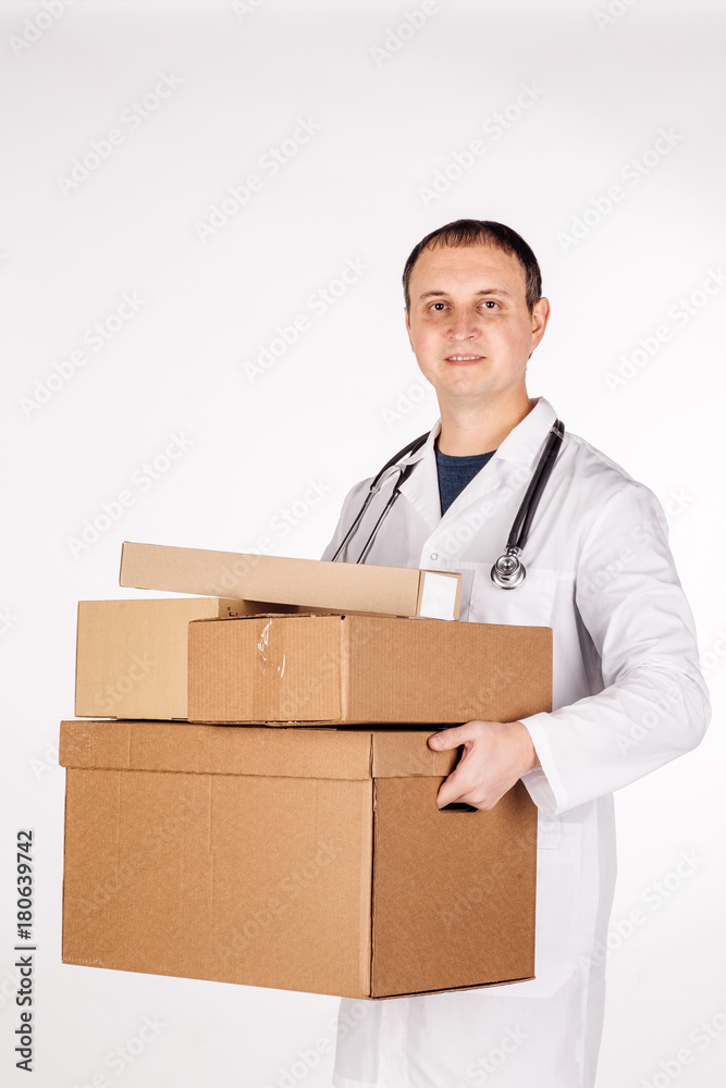 doctor smiling, holding box and looking at camera. image on a white studio background. doctor smiling, holding box and looking at camera. image on a white studio background.