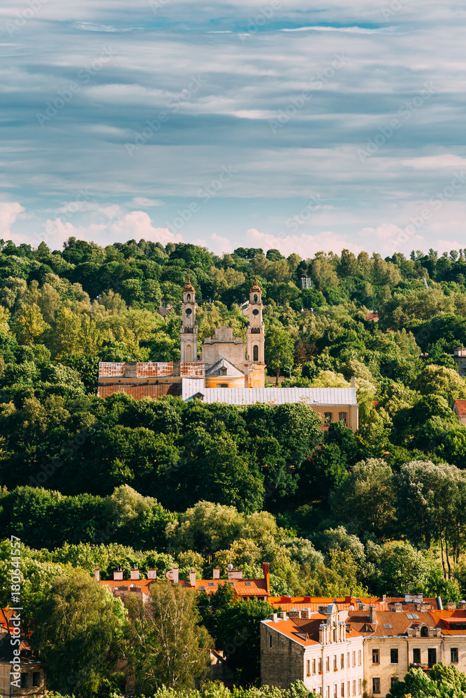 Vilnius, Lithuania. View Of Old Catholic Church Of Ascension Among Green Foliage