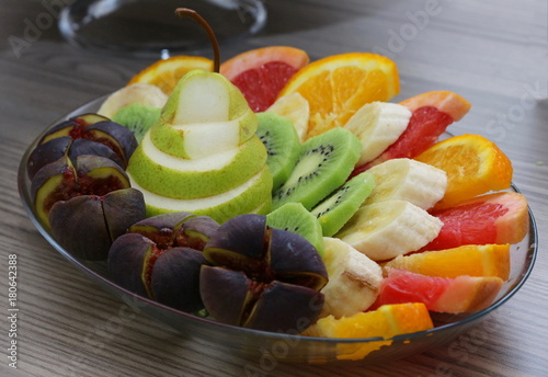 Sliced healthy fresh fruit on plate. photo