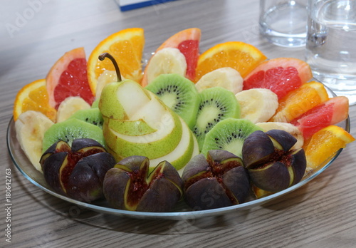 Sweet fresh fruits on glass plate. photo