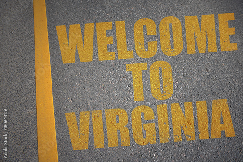 asphalt road with text welcome to virginia near yellow line.