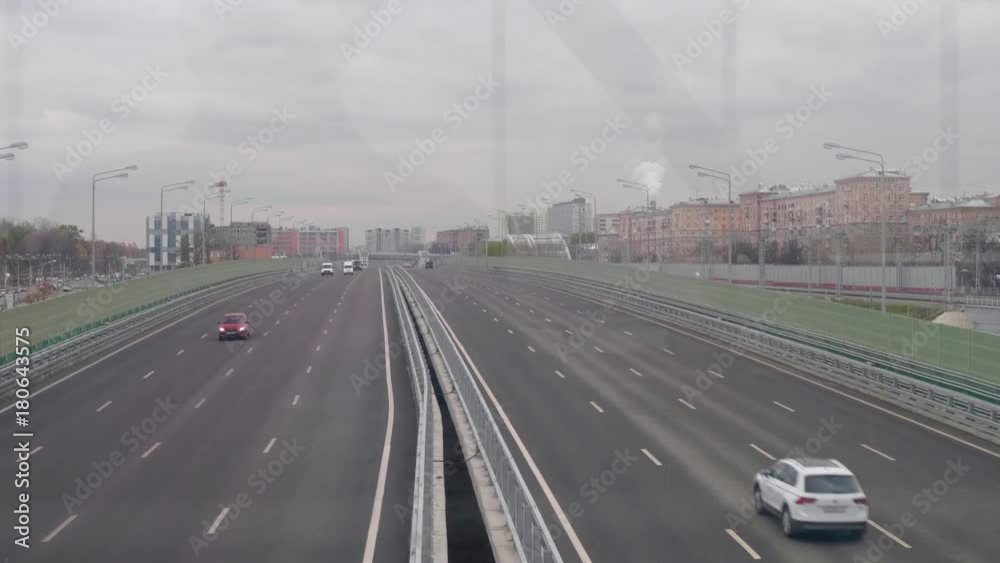 View from bridge of large city road with cars moving on it View from bridge of large city road with cars moving on it