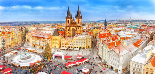 Prague in Christmas time. Winter snowy scenery. Classical panoramic view on old Town Square and Tyn church with Christmas fair market in Prague , Czech Republic. New Year festive time.