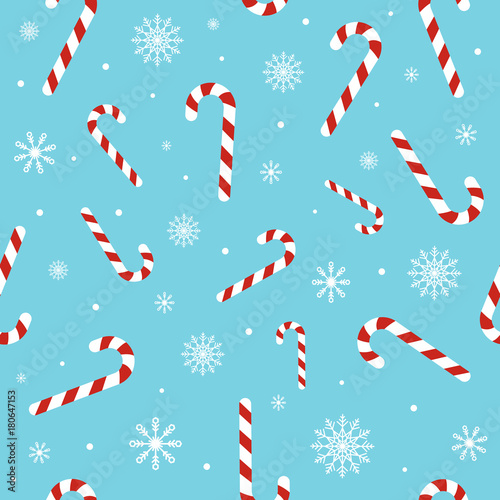 Christmas seamless pattern with candy canes, snowflakes, snow ball on blue background. Background for wrapping paper, fabric print, greeting cards. Winter Holiday design