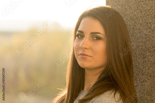 Young teenage girl portrait headshot against wall with serious look