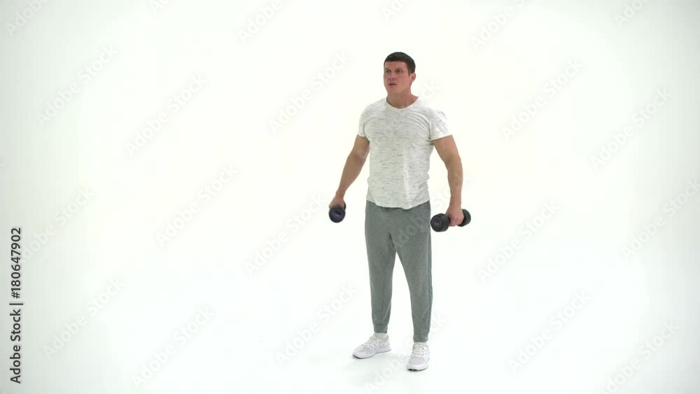 Fitness athlete man Working Out With Dumbbells in studio on a white background 4K Fitness athlete man Working Out With Dumbbells in studio on a white background 4K