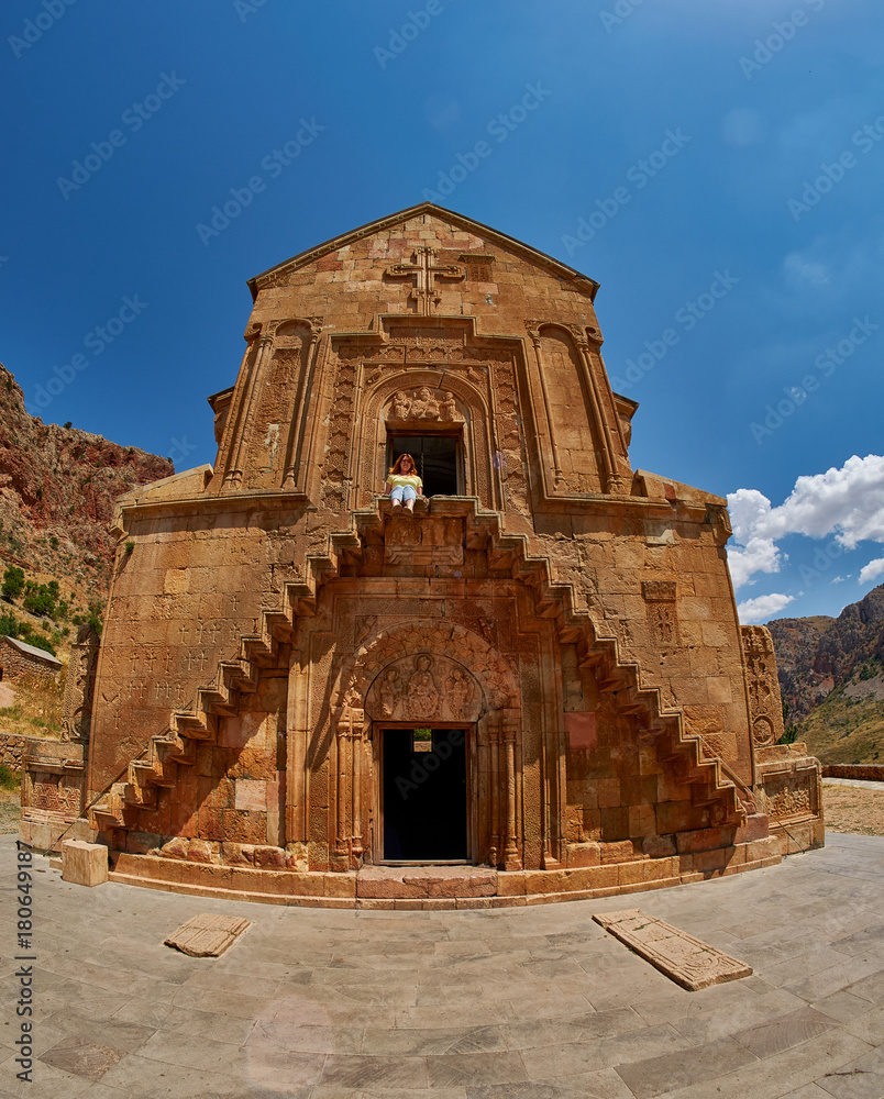 Young Woman climbing steep stairs of Noravank Monastery
