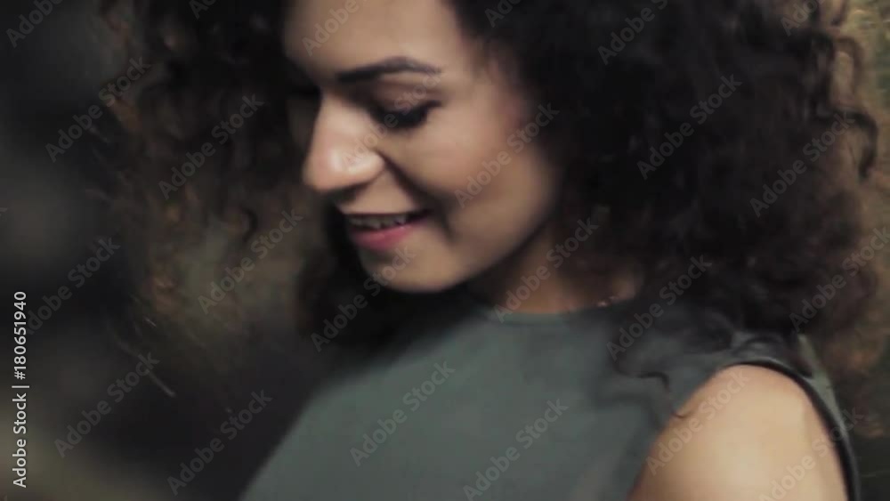 video portrait of a charming curly-haired girl. Flirts and laughs at the camera. Brunette video portrait of a charming curly-haired girl. Flirts and laughs at the camera. Brunette