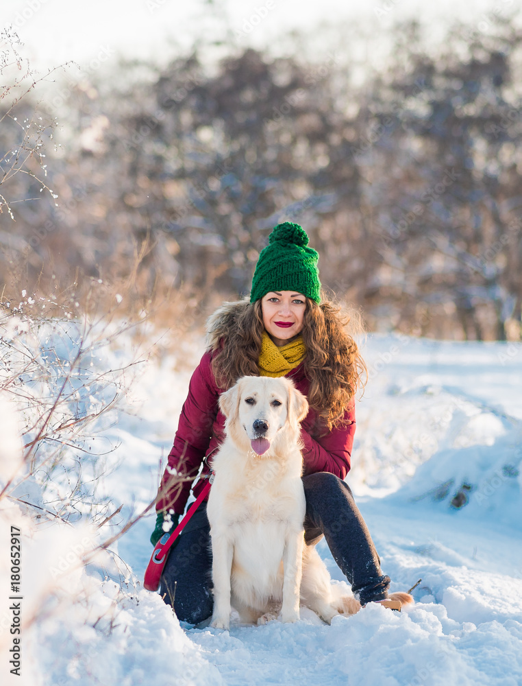 Close up happy woman owner and white golden retriever dog in winter day Close up happy woman owner and white golden retriever dog in winter day