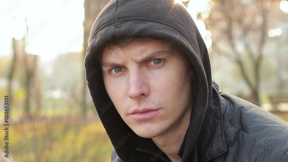 Young man looking at camera with hatred. Irritated look of a man