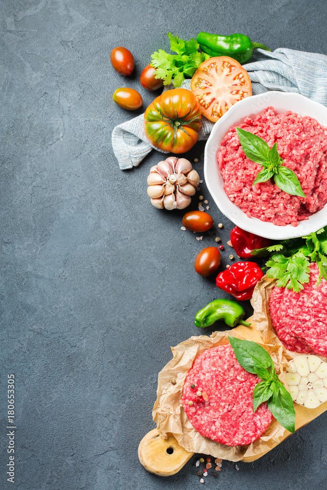 Homemade raw organic minced beef meat burger cutlet and vegetables Homemade raw organic minced beef meat burger cutlet and vegetables