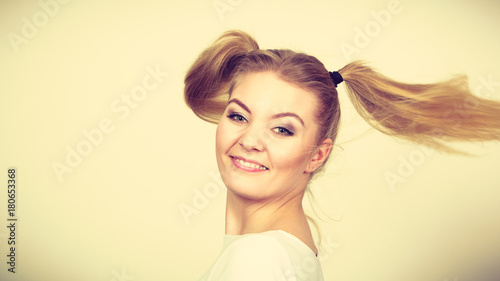 Happy blonde teenager girl with ponytails