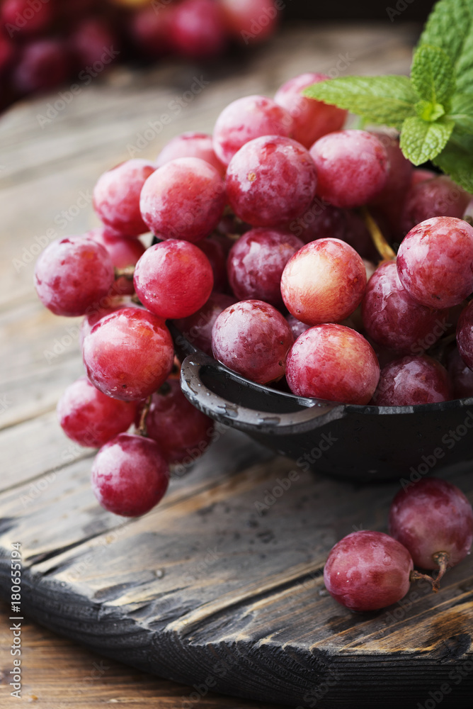 Sweet red grape on the wooden table Sweet red grape on the wooden table