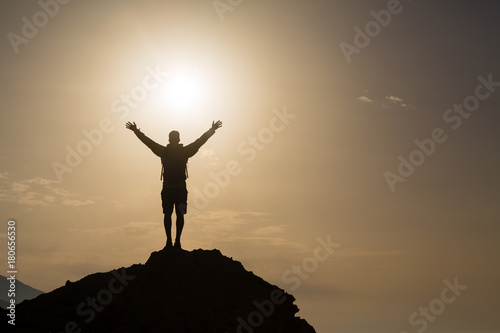 Man with arms outstretched celebrate mountains sunrise © blas